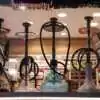 A group of hookahs on a shelf at Pipe King LLC LA Wholesale Smoke Shop and Accessorie
