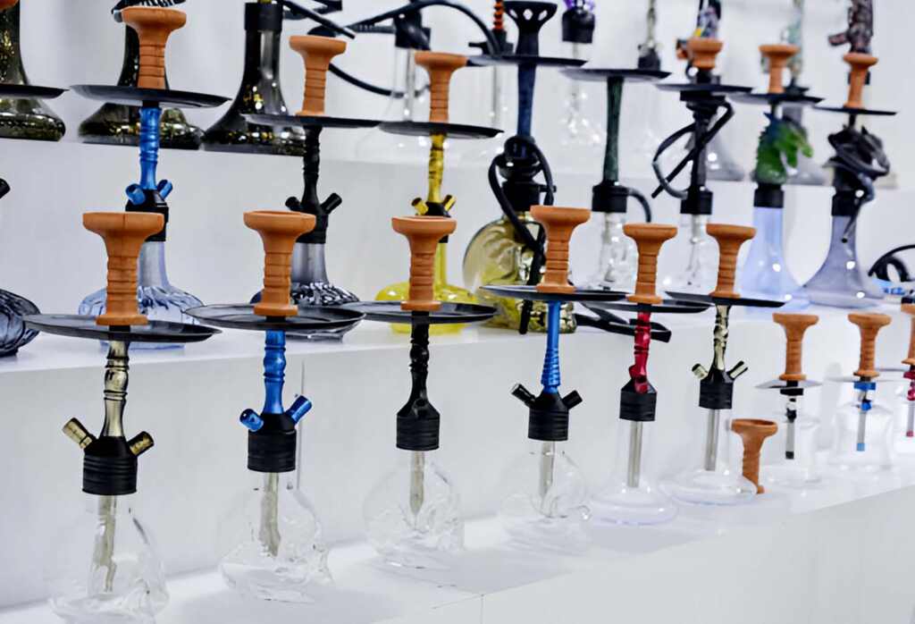 Assorted hookahs lined up on store shelf – Pipe King LLC Los Angeles Wholesale Smoke Shop