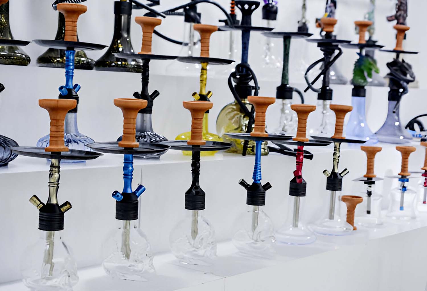 Assorted hookahs lined up on store shelf – Pipe King LLC Los Angeles Wholesale Smoke Shop